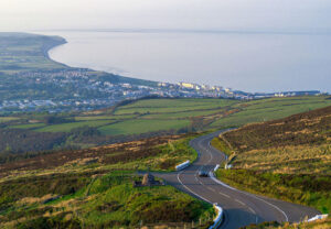 Scenic road through Isle of Man countryside overlooking the coast and sea