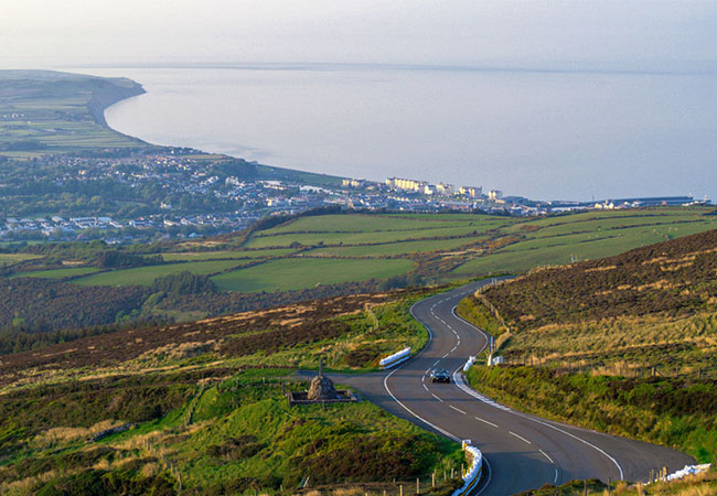 Scenic road through Isle of Man countryside overlooking the coast and sea